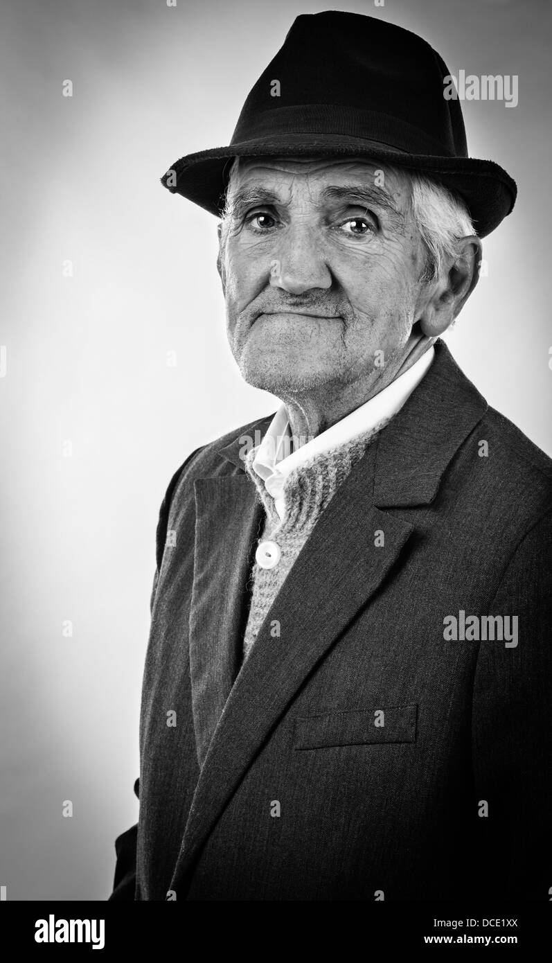 Monochrome portrait of an expressive old man with hat Stock Photo