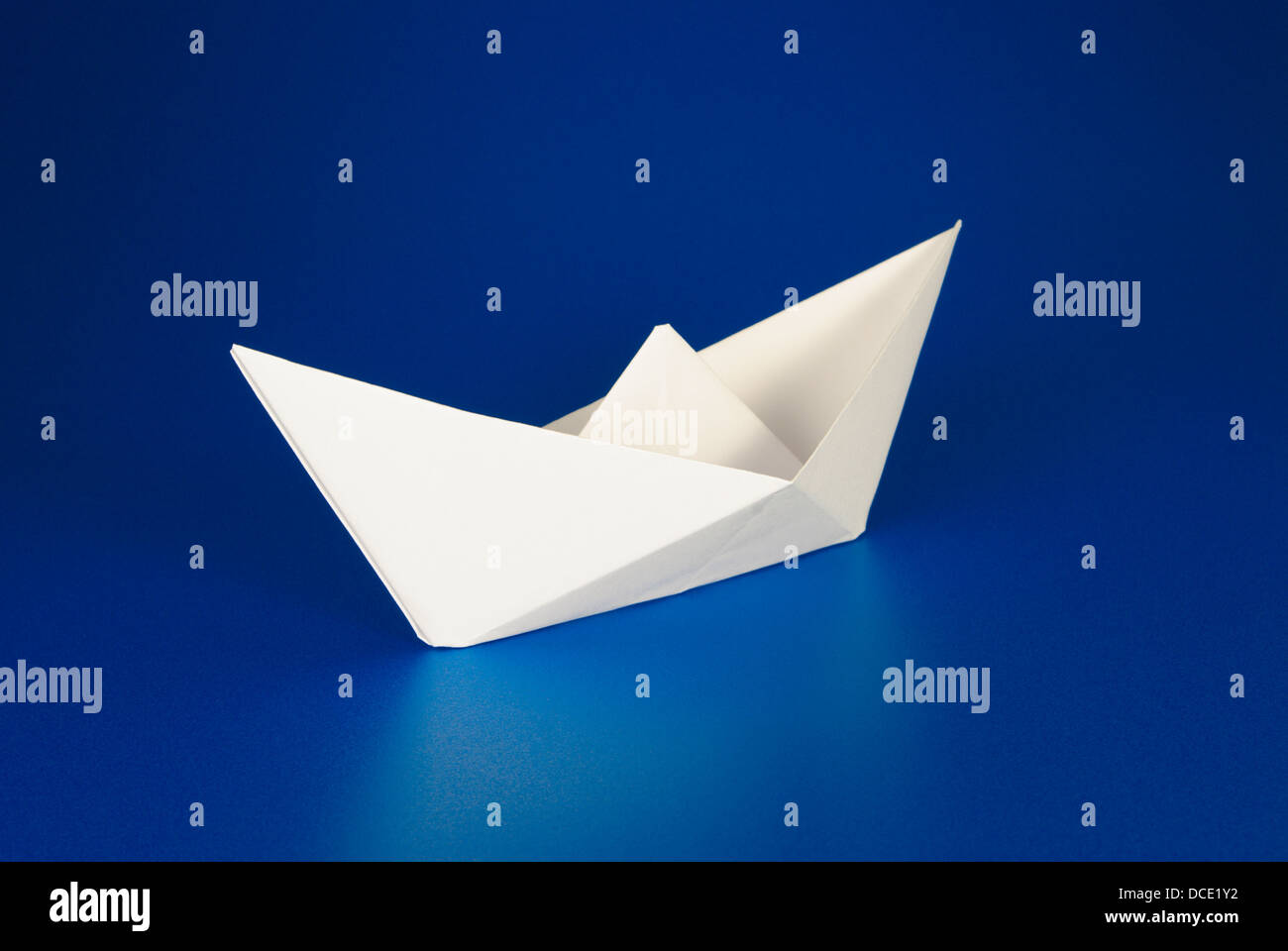 Paper boat over blue background Stock Photo