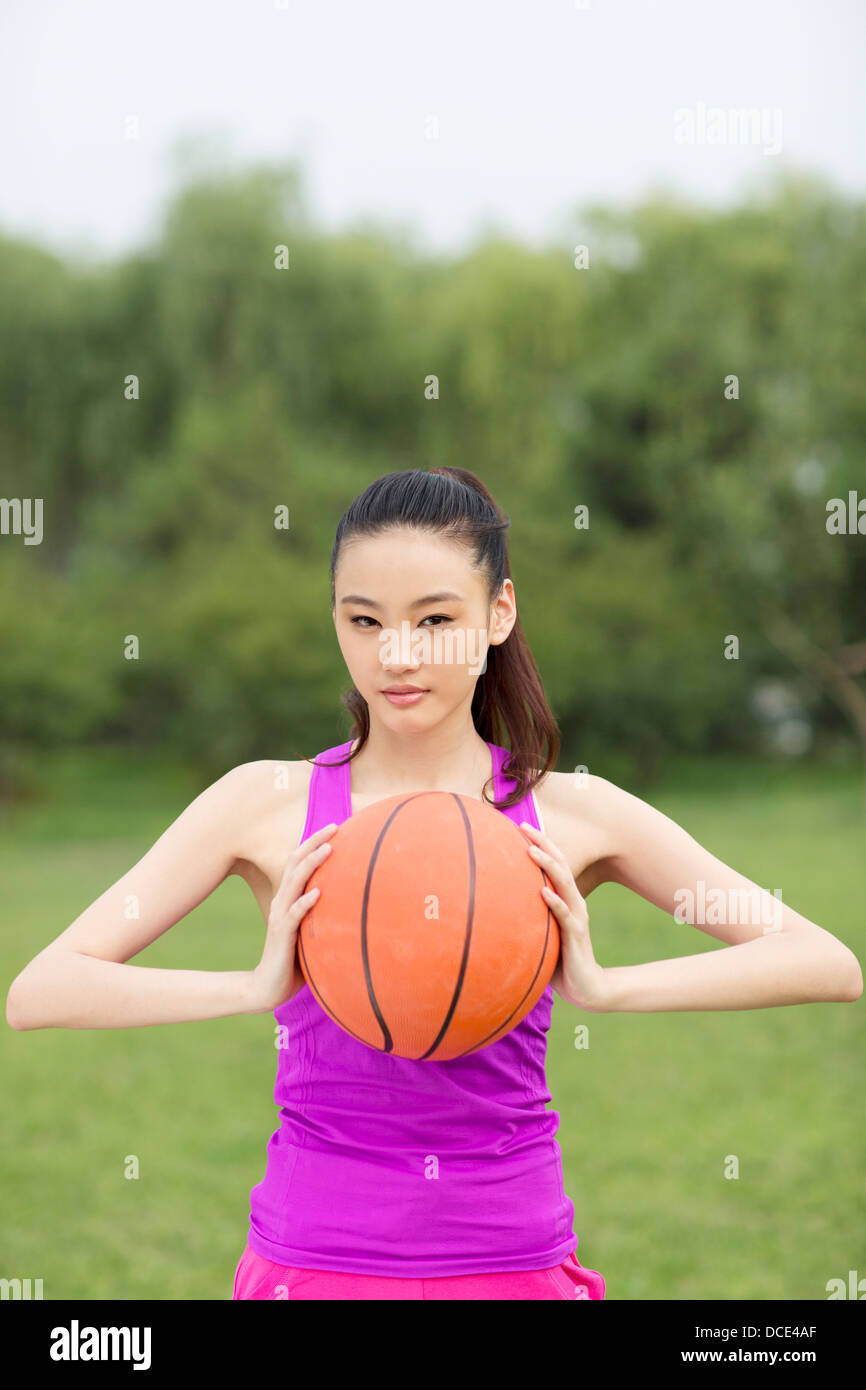 Young woman holding a basketball Stock Photo - Alamy