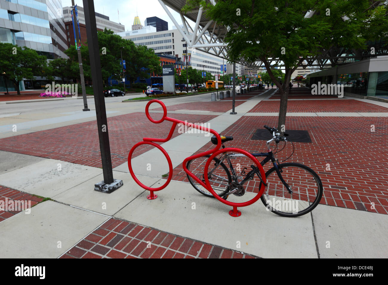 Red steel bicycle shaped cycle rack for securing bikes outside Convention Center building, Baltimore City, Maryland, USA Stock Photo