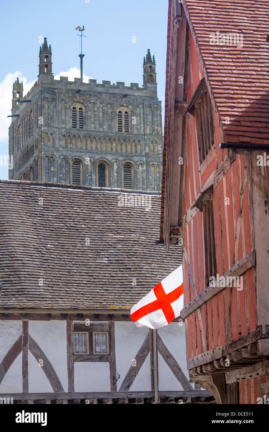Tewkesbury Abbey central tower, medieval half-timbered houses and English flag Tewkesbury Gloucestershire England UK Stock Photo