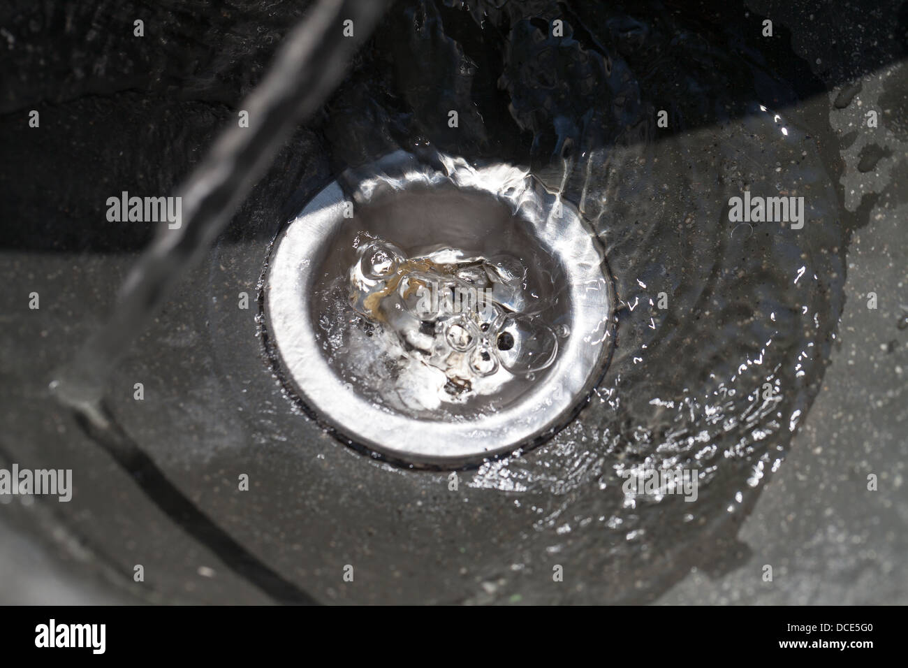 Water flows into drain hole, closeup Stock Photo Alamy