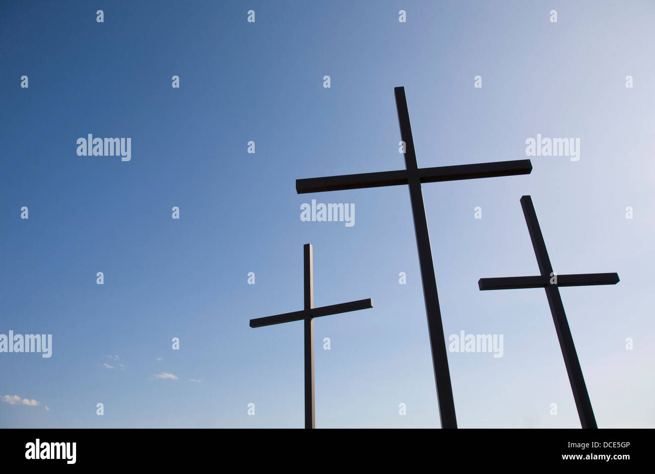 Three Crosses Against Blue Sky Stock Photo