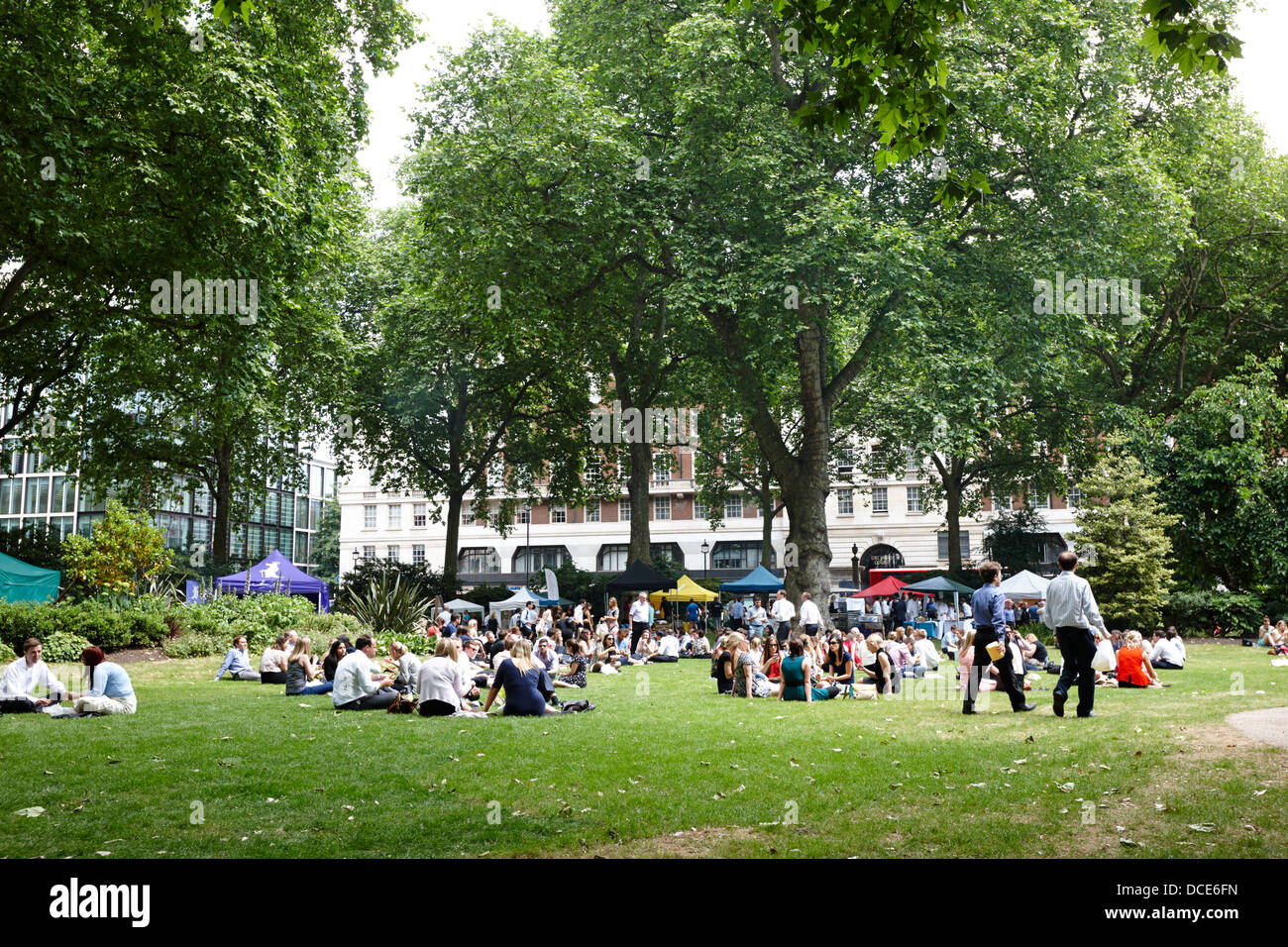 local workers enjoying lunchtime at portman square London England UK Stock Photo