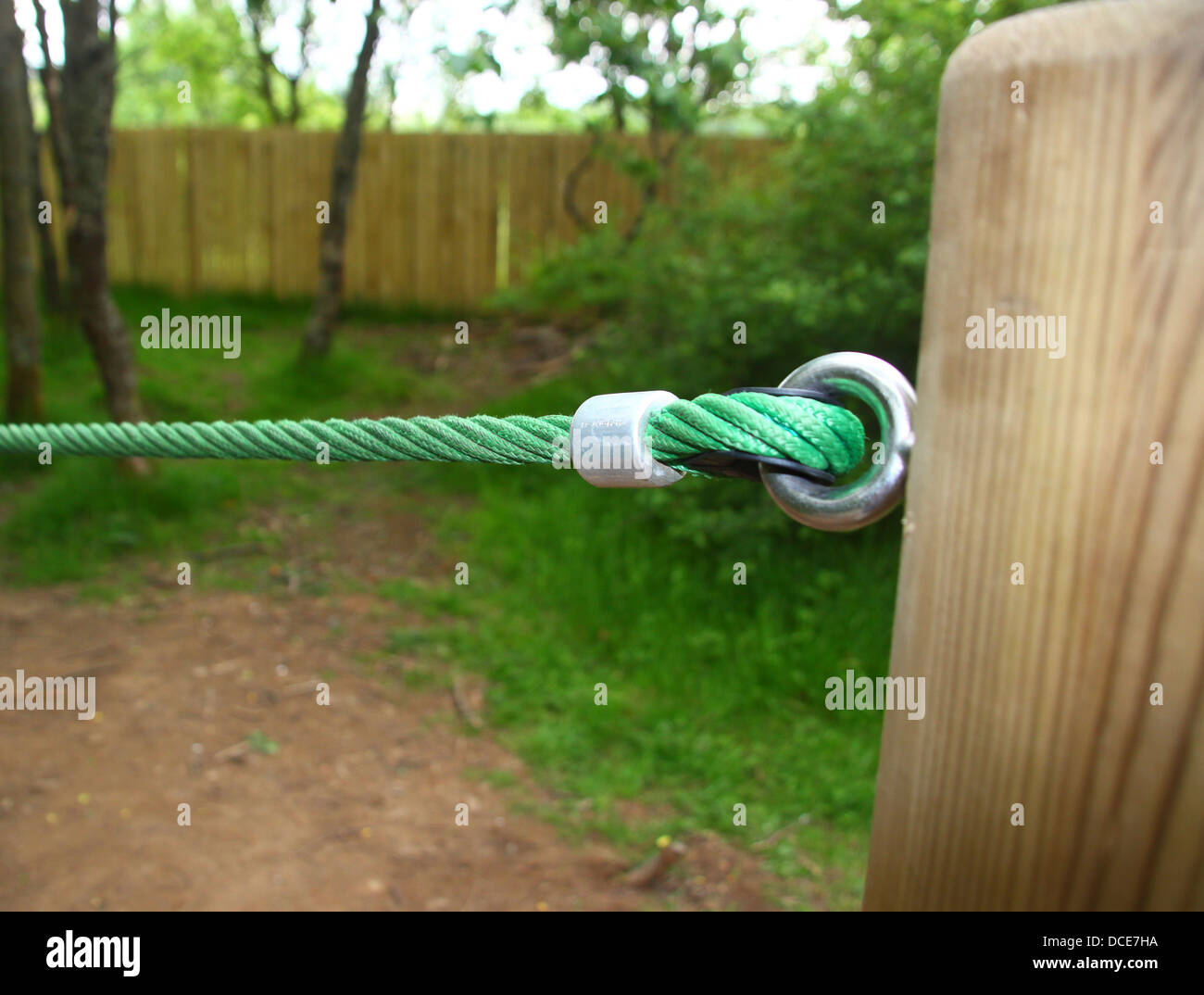 Tensioned rope barrier on wooden post Stock Photo Alamy