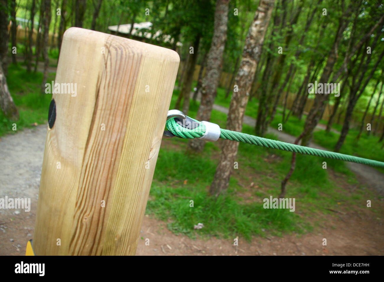 Tensioned rope barrier on wooden post Stock Photo Alamy