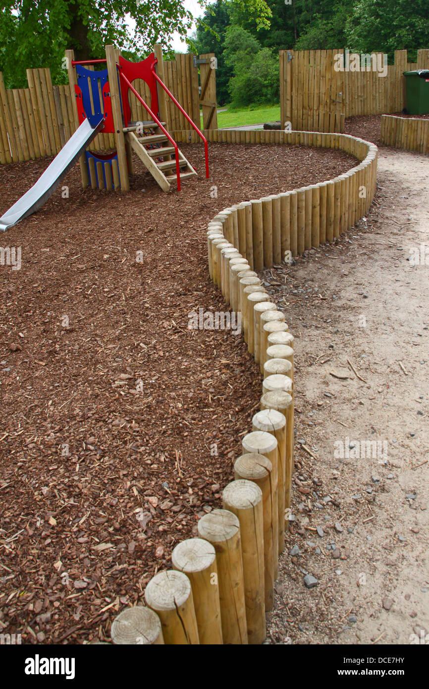 Curved wooden log fence in playground Stock Photo