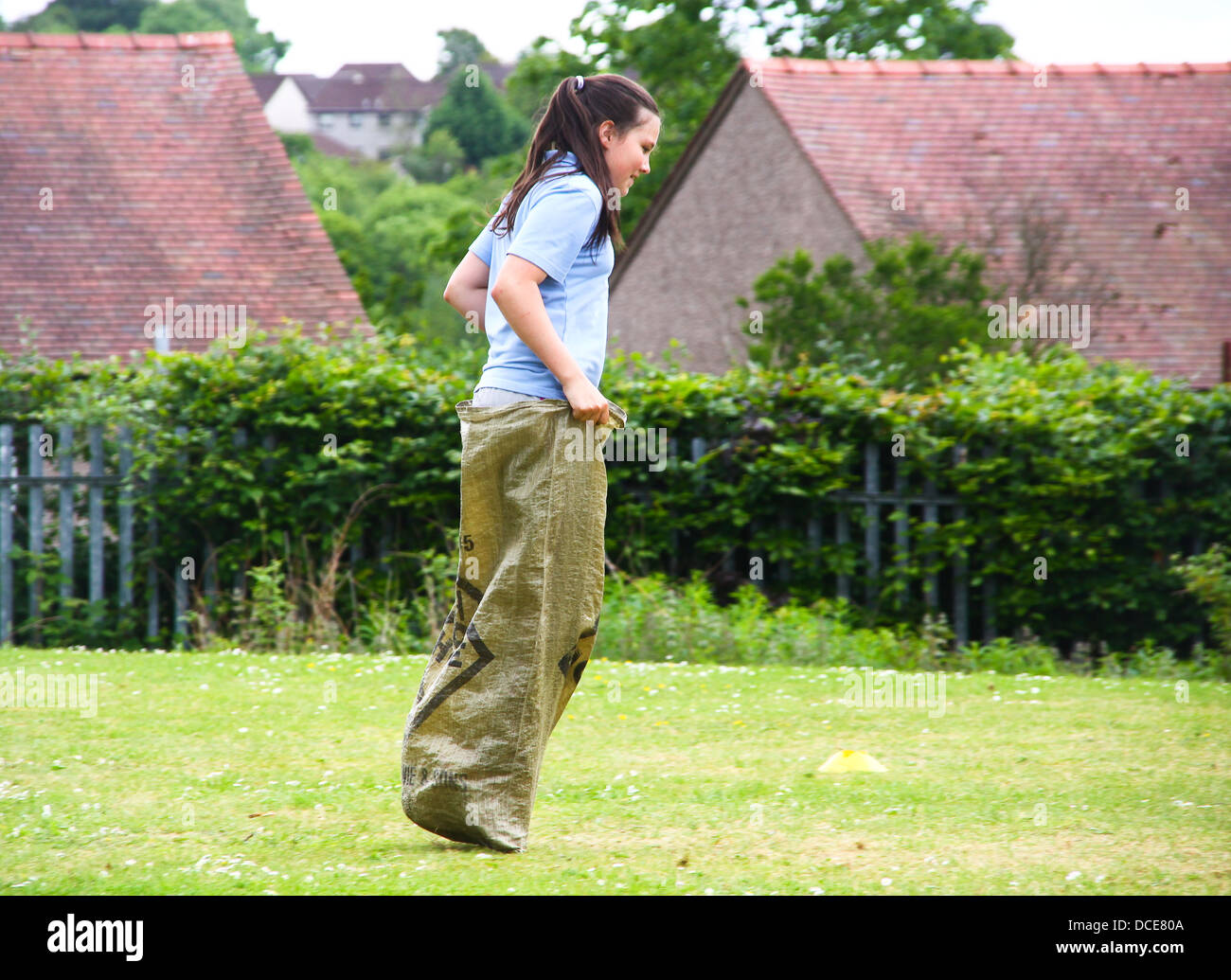 Young girl doing sack race in school sports Stock Photo