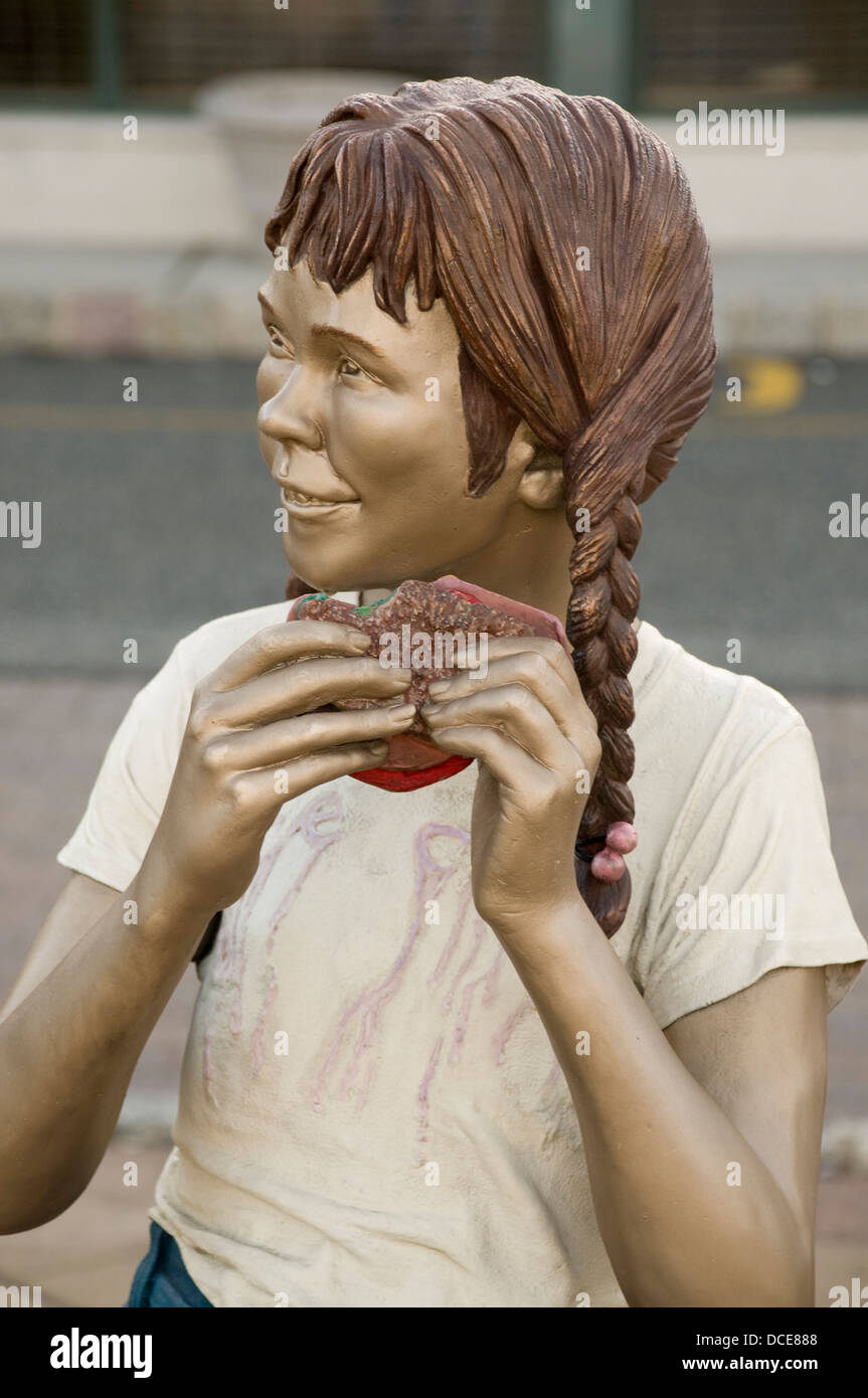Sculpture of a girl eating called 'Yum Yum' by J. Seward Johnson ©1982 Stock Photo