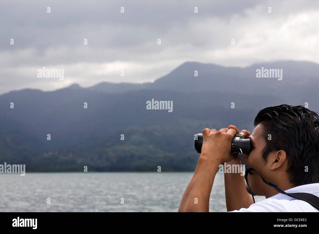 Hispanic Man Looking Through Binoculars, Costa Rica Stock Photo Alamy