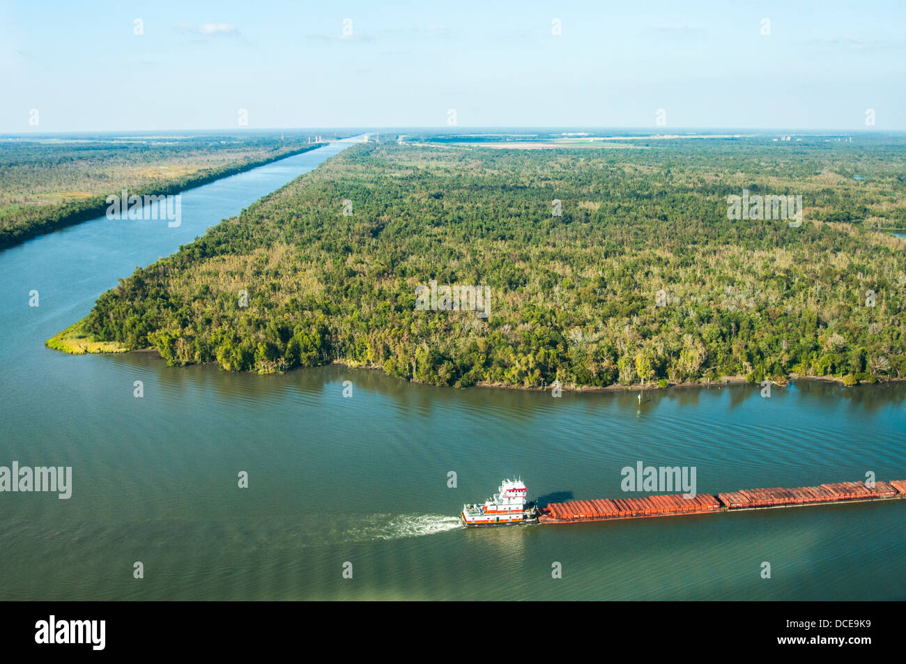 USA, Louisiana, Atchafalaya Basin, intersection of Intracoastal Waterway and Wax Lake Outlet, tugboat pushing barge of freight. Stock Photo