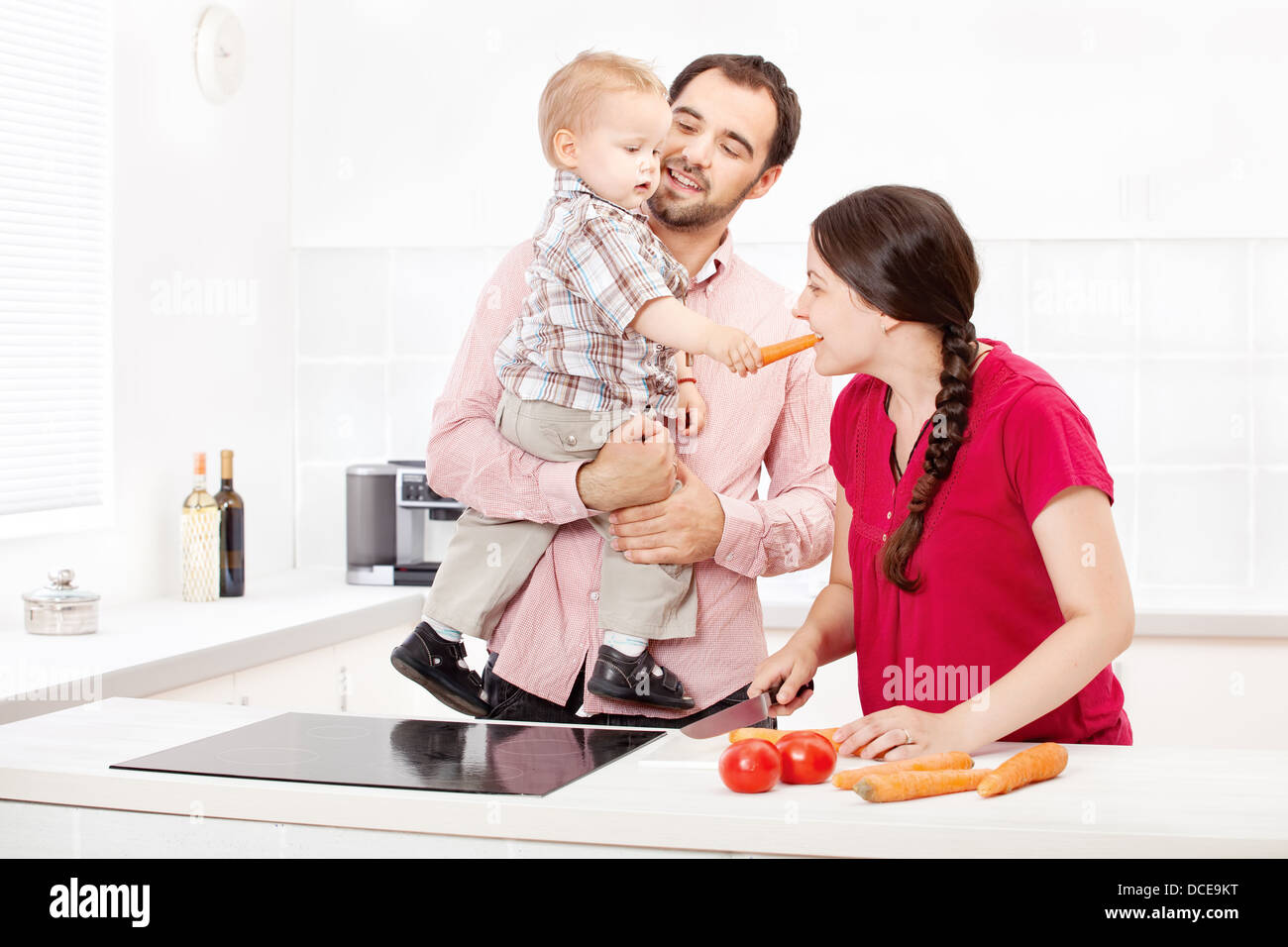 Happy family preparing food in the kitchen Stock Photo