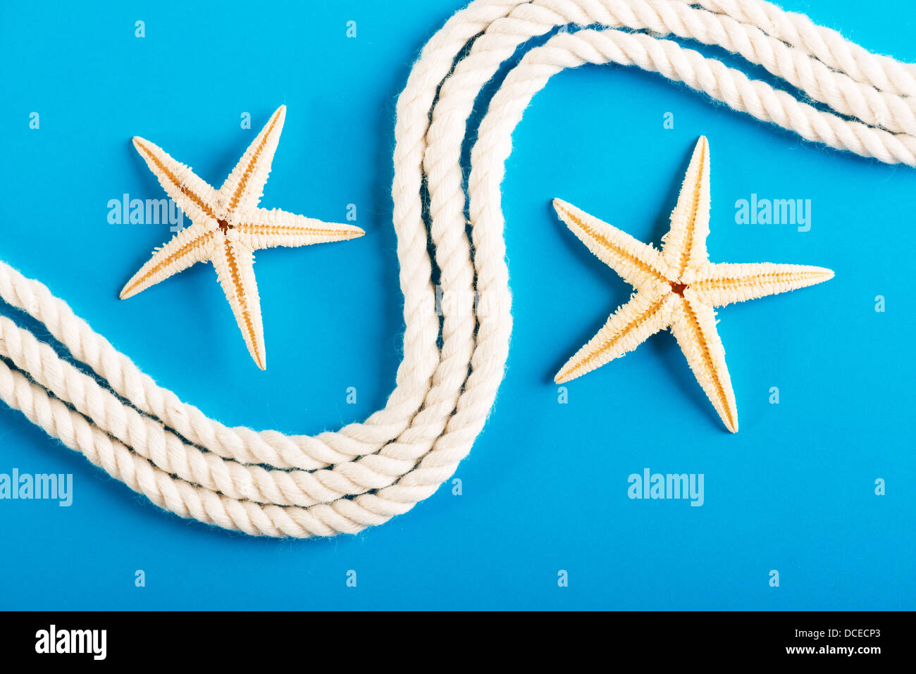 Rope and starfish on blue Stock Photo - Alamy
