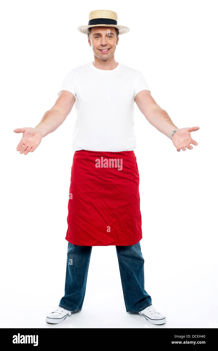Cool young guy you. Wearing hat and apron tied on his waist