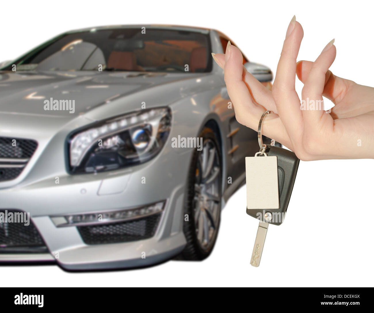 Elegant female hand holding car keys against expensive premium class auto Stock Photo