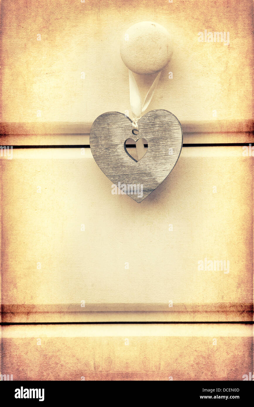 Macro retro cross processed effect image of wood heart on wooden background Stock Photo