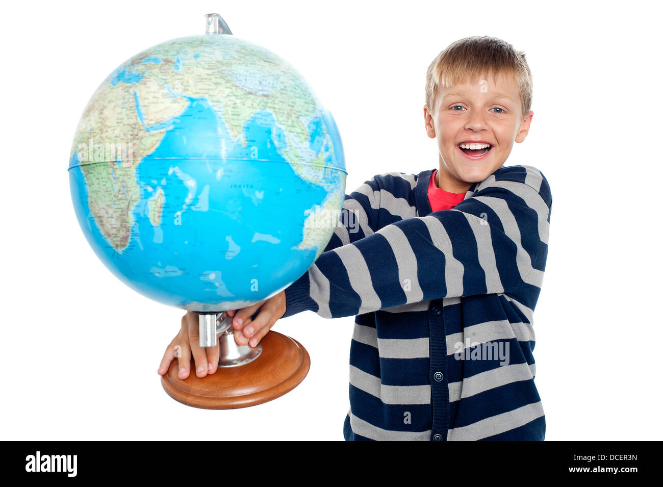 An excited school boy holding globe in his outstretched arms isolated against white background Stock Photo
