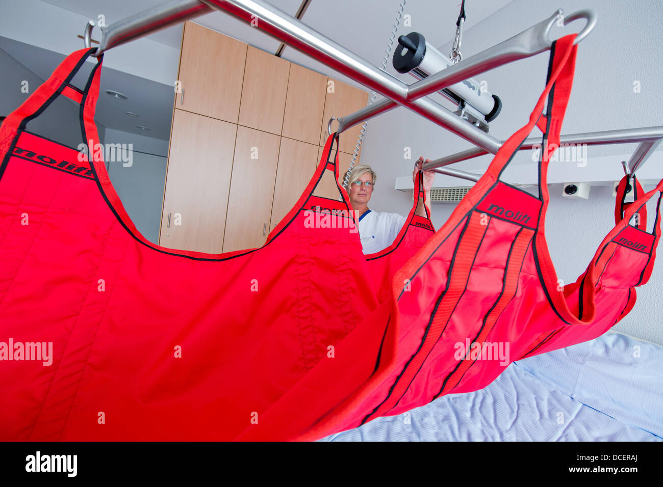 Nurse Heike Wollenhaupt demonstrates a special bed for obese people at