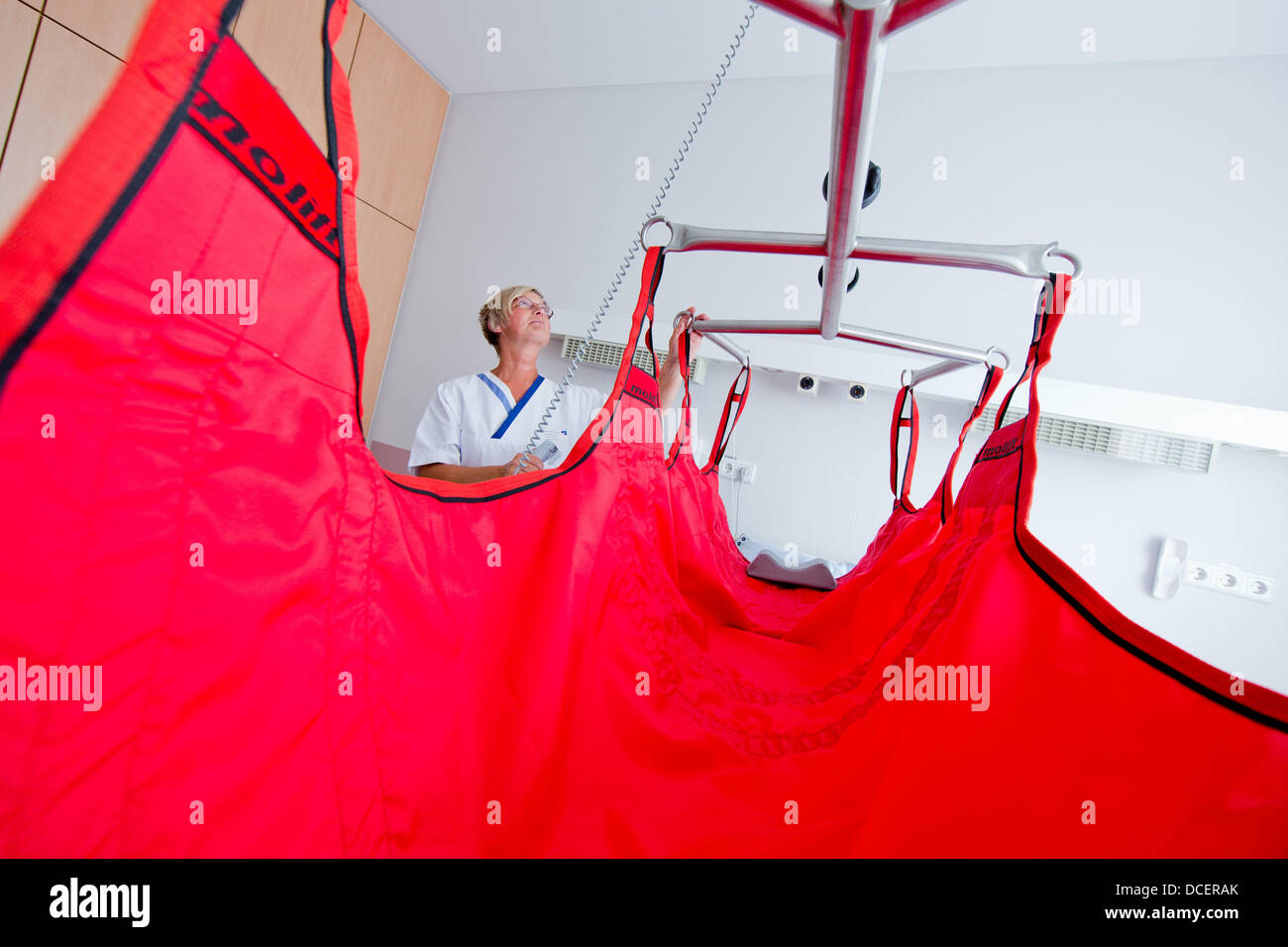 Nurse Heike Wollenhaupt demonstrates a special bed for obese people at