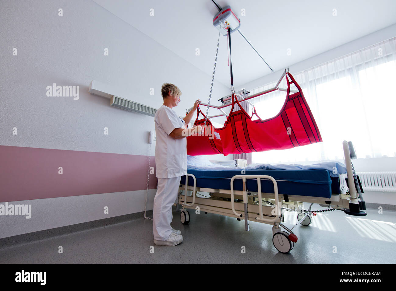 Nurse Heike Wollenhaupt demonstrates a special bed for obese people at