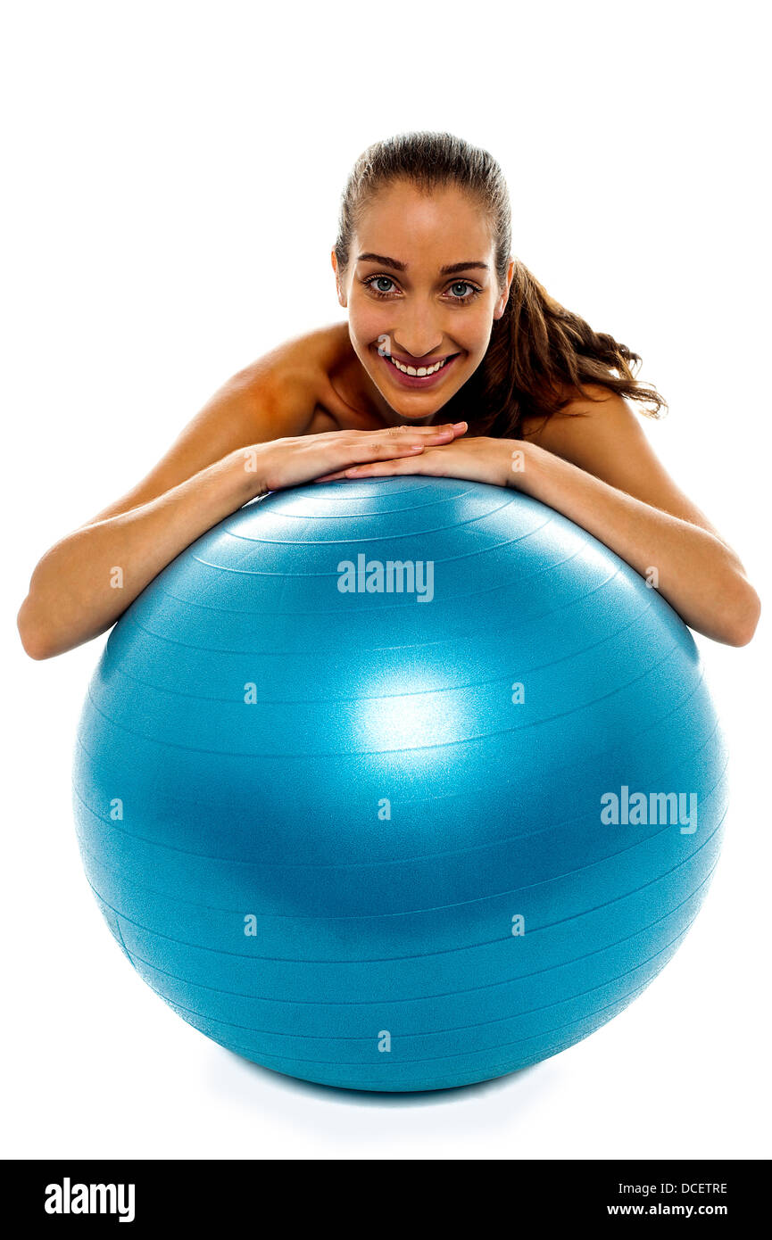 Woman leaning over big blue swiss ball and smiling at camera Stock ...