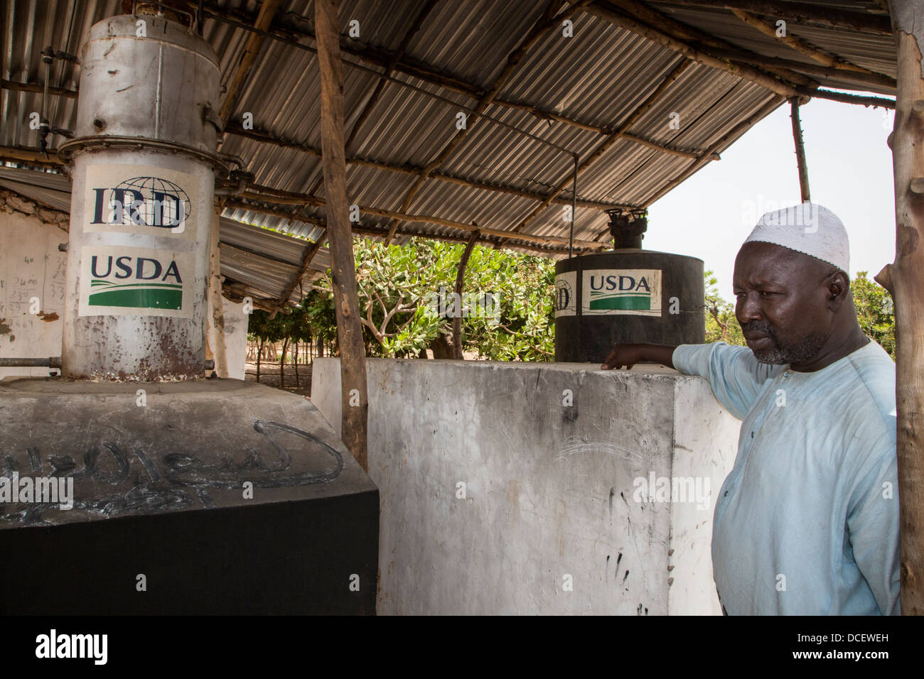 Cashew Nut Farmer with Boiler for Drying Nuts. Mendy Kunda, North Bank Region, The Gambia Stock Photo