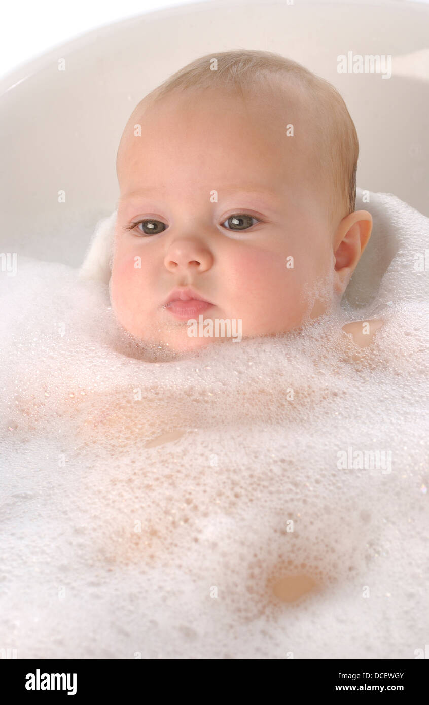 Baby girl in a bathtub with foam Stock Photo Alamy