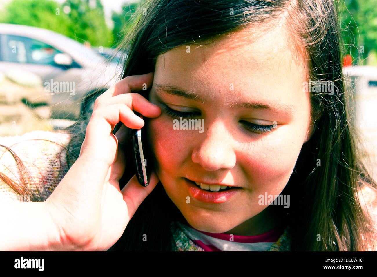 Young girl talking on iPhone Stock Photo