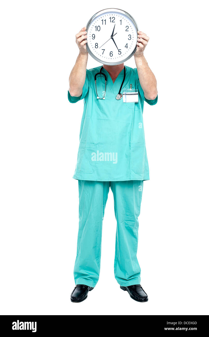 Surgeon holding a clock. Time is critical for the patient's survival. Stock Photo