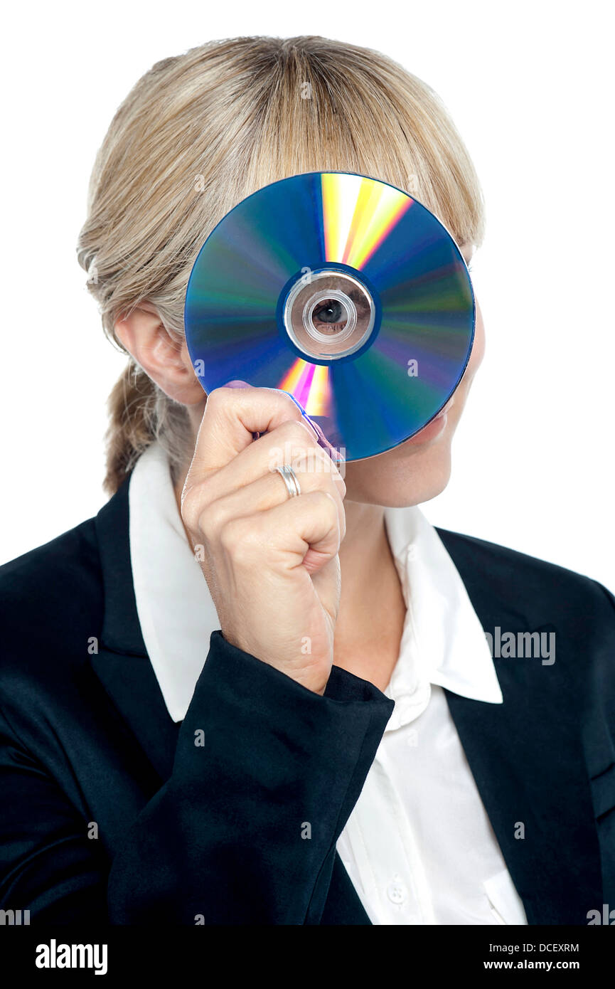 Young corporate lady looking at you through compact disc hole and ...