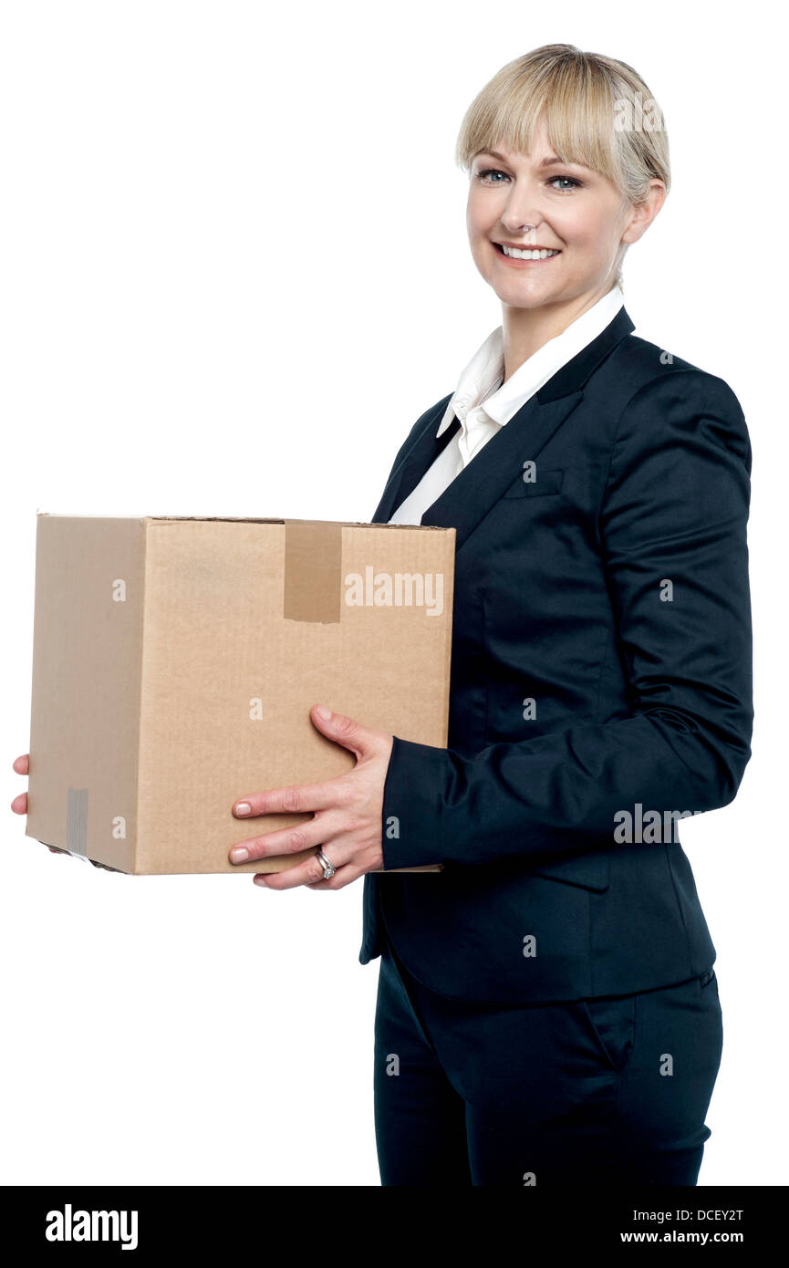 Corporate woman with a cardboard box in hand. Shifting her office Stock