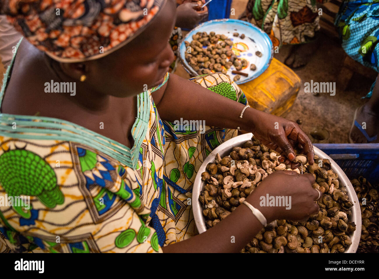 Woman Removing Cashew Nut from Hull, Cashew Processing Center, Group Dimbal Djabott, Mendy Kunda, North Bank Region, The Gambia Stock Photo