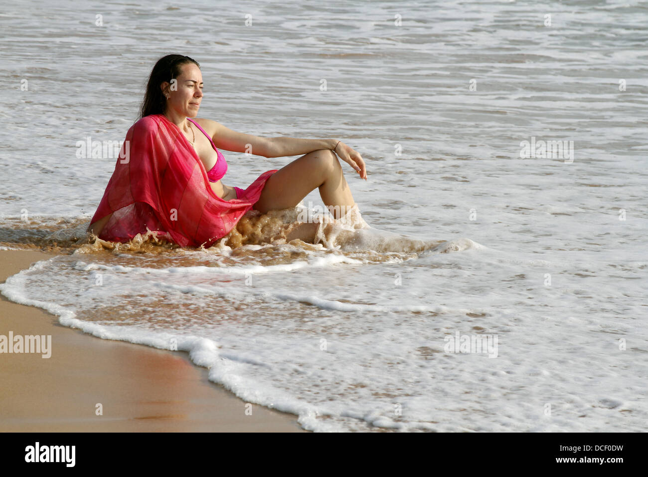 WOMAN RELAXES ON BEACH BENTOTA SRI LANKA 13 March 2013 Stock Photo