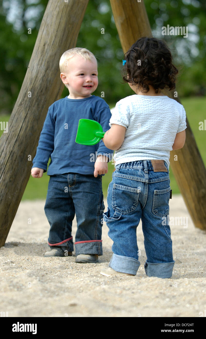 Two toddlers playing in the park Stock Photo