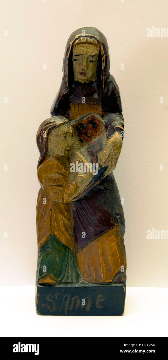 Statuette of Saint Anne, patron of Brittany, teaching her daughter Virgin Mary to read. Polychrome Wood. Stock Photo