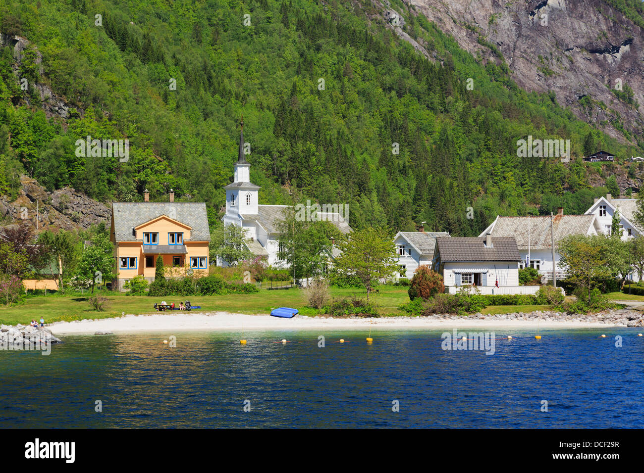 View along Mofjorden fjord to beach and church in pretty village of Mo ...