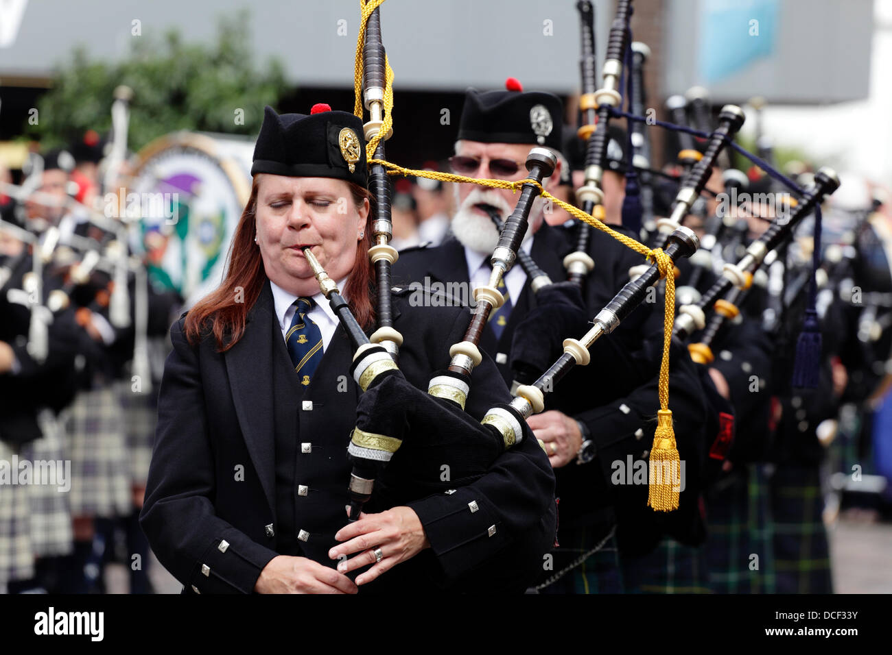 Saint Enoch Square, Glasgow, Scotland, UK, Friday, 16th August, 2013. Pipe Major Bethany Bisaillion leads Sons Of Scotland Pipe Band from Ottawa, Canada as four pipe bands take part in the traditional Beat The Retreat during the Piping Live! Festival. Stock Photo