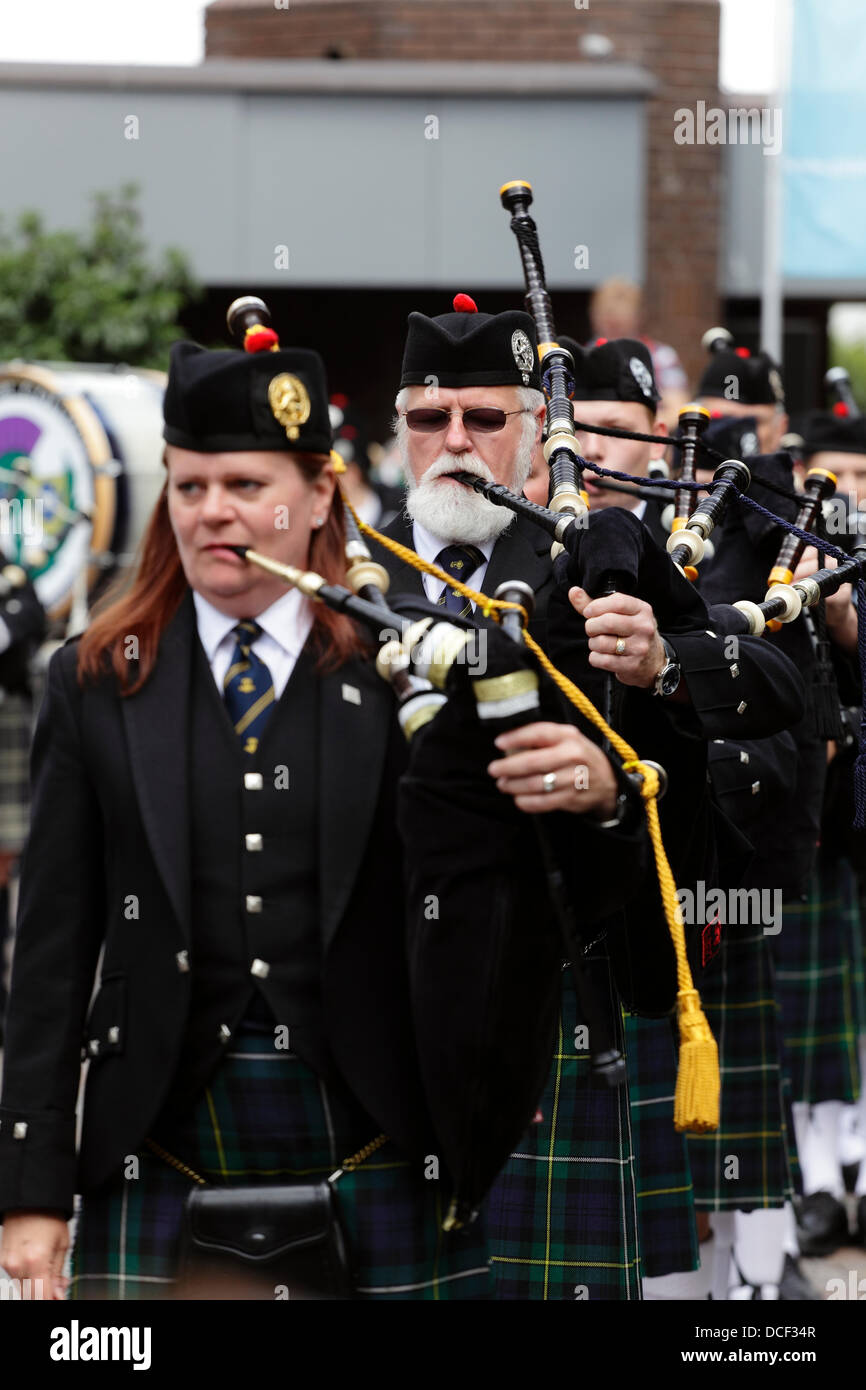 Saint Enoch Square, Glasgow, Scotland, UK, Friday, 16th August, 2013. Pipe Major Bethany Bisaillion leads Sons Of Scotland Pipe Band from Ottawa, Canada as four pipe bands take part in the traditional Beat The Retreat during the Piping Live! Festival. Stock Photo