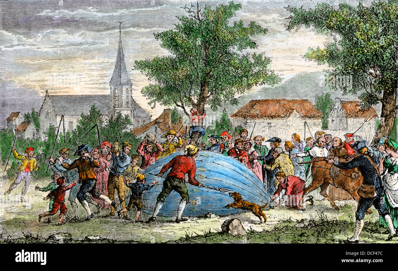 Unexpected descent of the first hydrogen balloon into a French village, 1783. Hand-colored woodcut Stock Photo