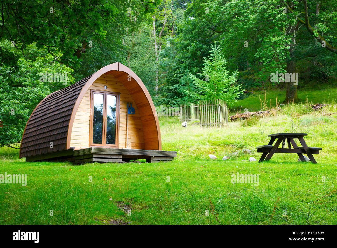 Camping Pod and picnic bench in a woodland clearing at Rydal Hall Ambleside Cumbria England United Kingdom Great Britain Stock Photo