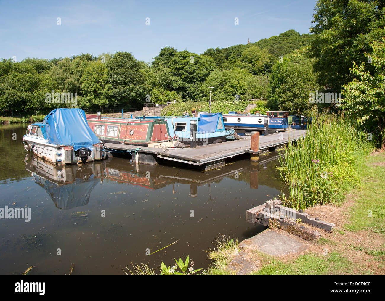 various types of boat at their moorings on the calder and hebble canal