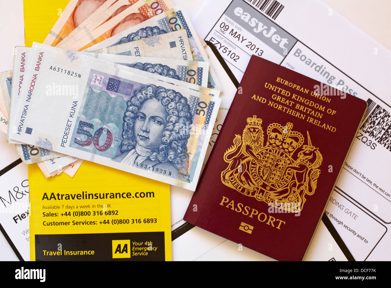 UK passport, travel insurance booklet, foreign currency money and Easyjet boarding pass ready for holiday to Croatia Stock Photo