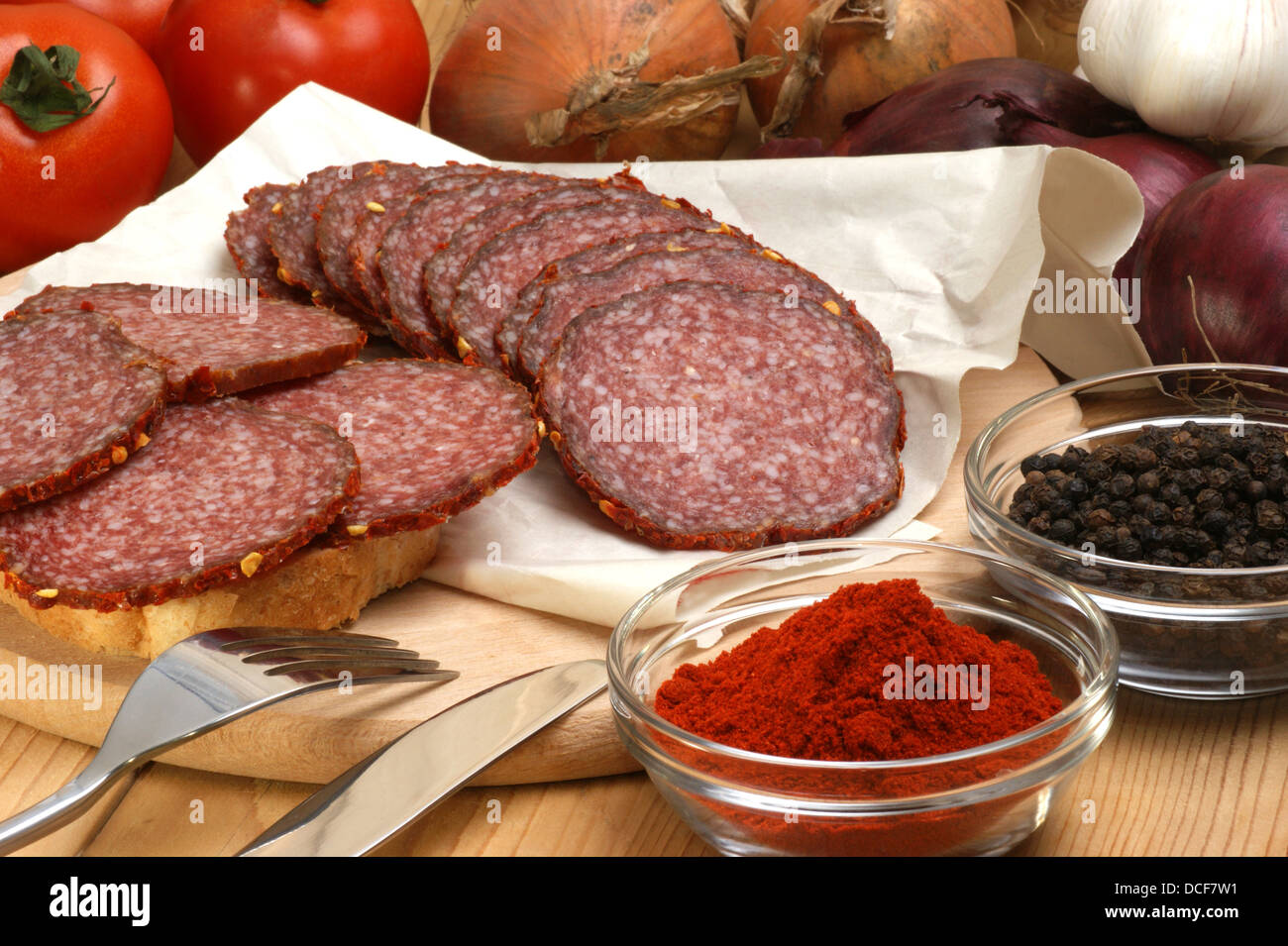 salami and some slices salami on a timber board Stock Photo - Alamy