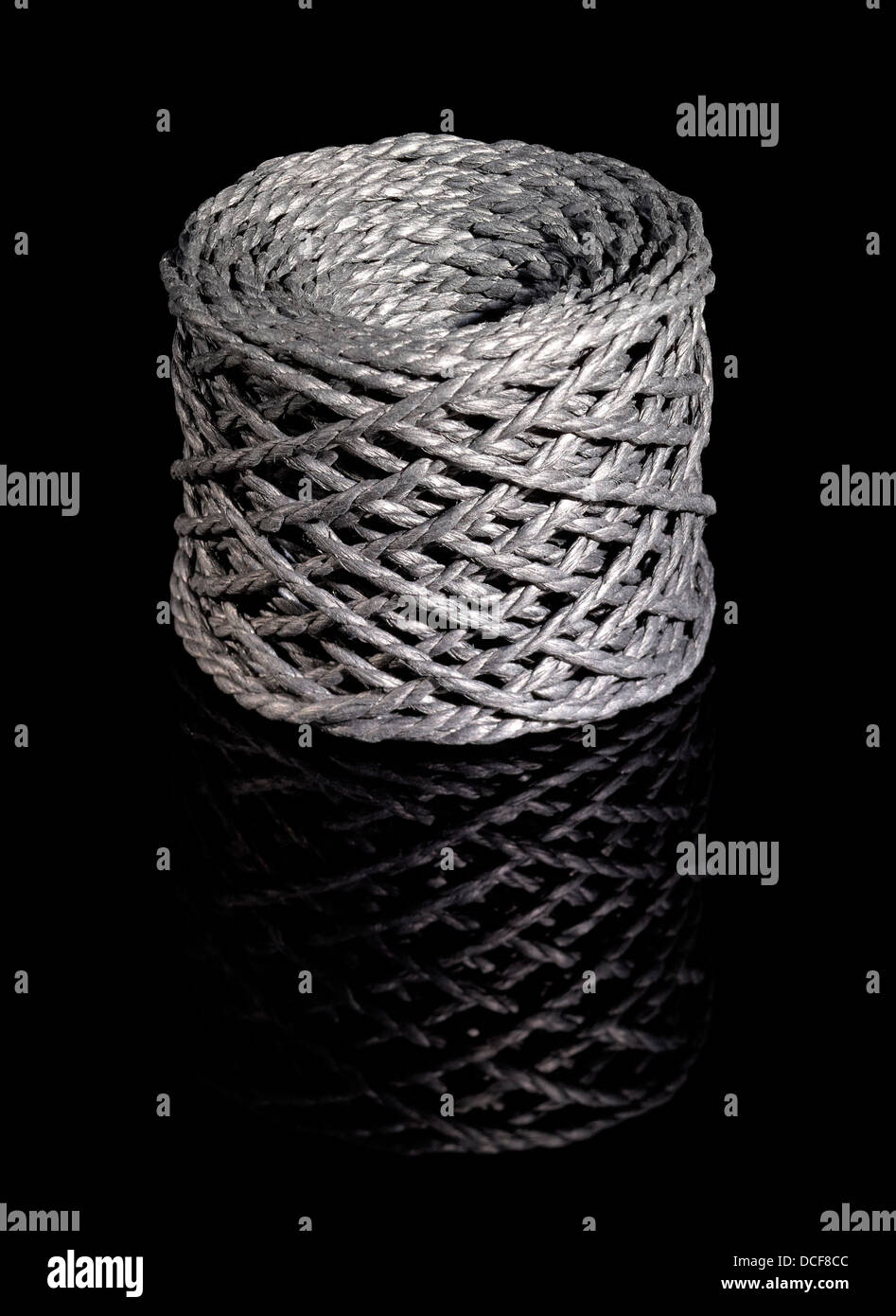 a grey string coil in black reflective back Stock Photo - Alamy