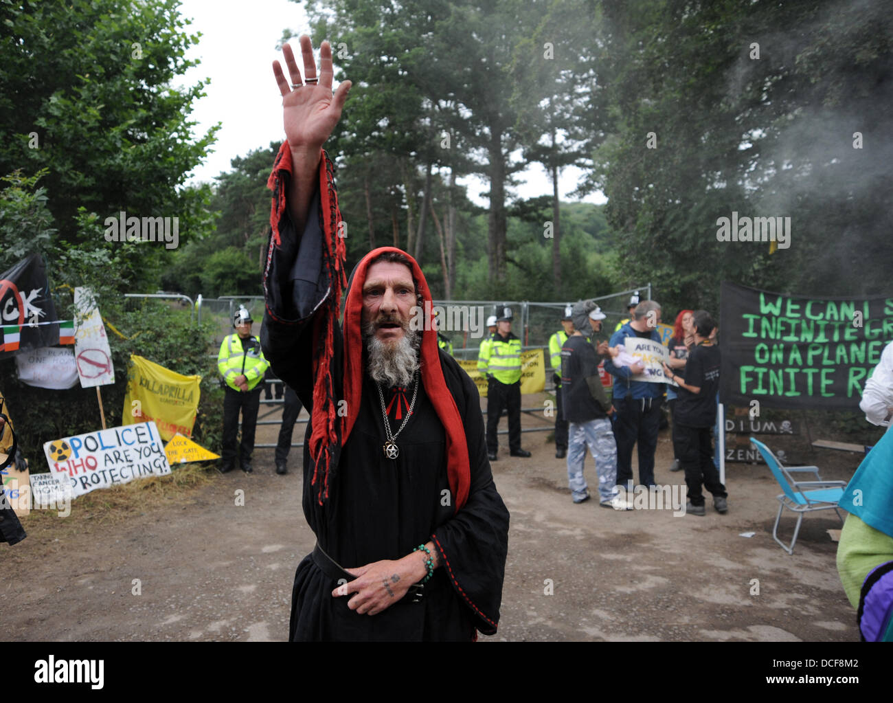 Balcombe Sussex UK 16 August 2013 - A druid performs a ritual at the entrance to the Cuadrilla site as Anti Fracking protesters gather in the West Sussex village of Balcombe where the company are carrying out exploration drilling . Thousands of protesters are expected to join the protest over the forthcoming weekend Stock Photo