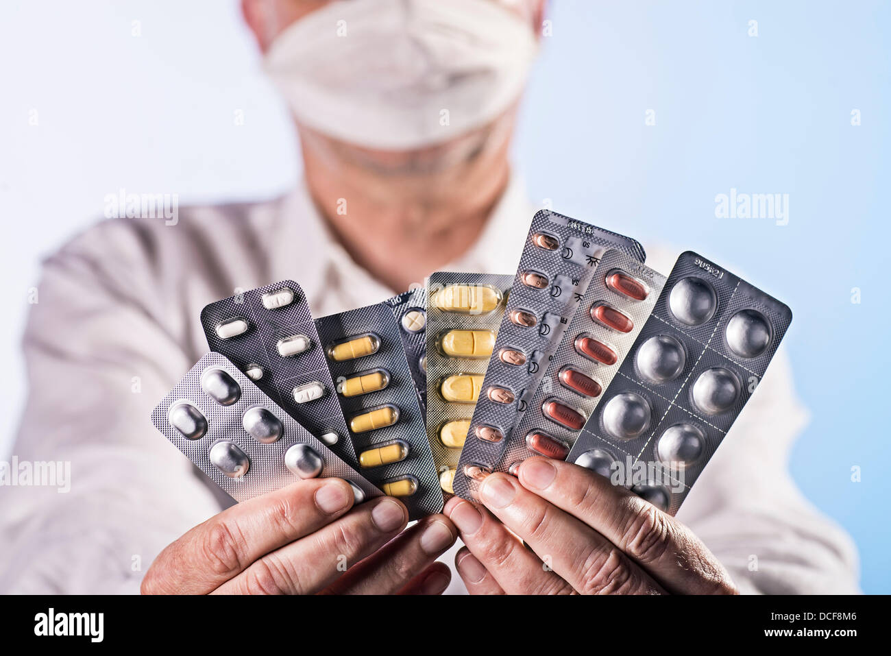 Doctor holds a lot of blisters with different drugs in his hands. Stock Photo
