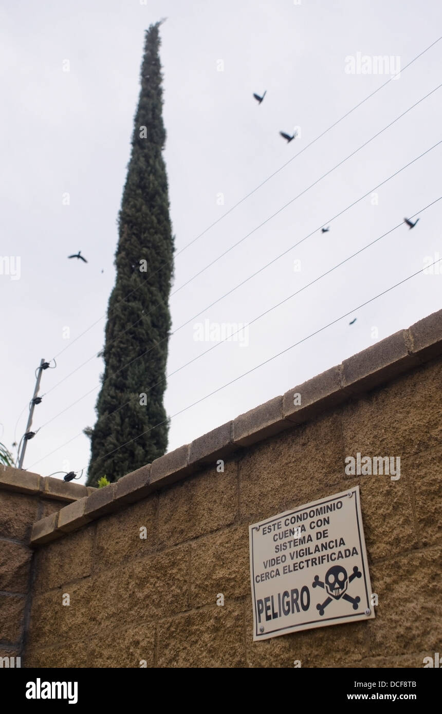 Mexico, Aguascalientes, Aguascalientes, Warning sign beneath electric fence Stock Photo