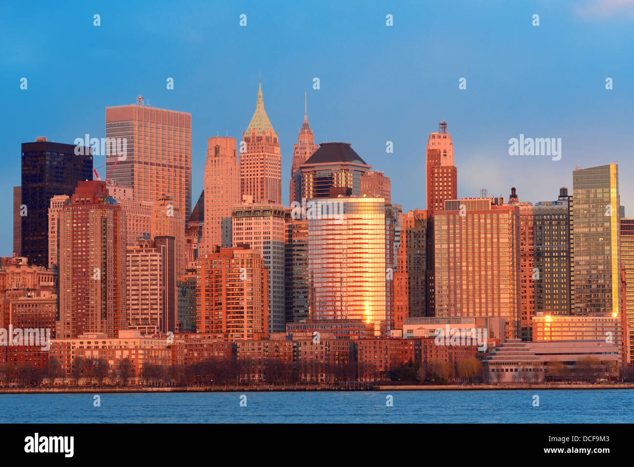 Downtown Manhattan skyline at sunset over Hudson River in New York City ...