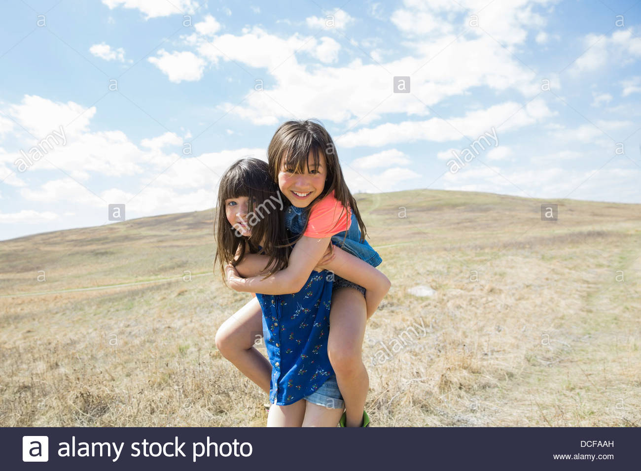 Little girl piggybacking female friend Stock Photo