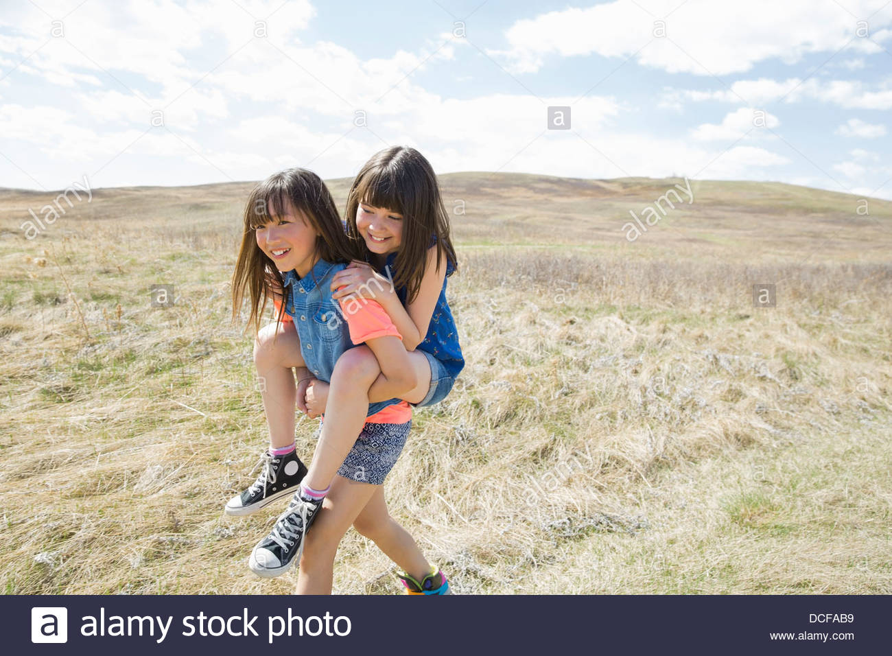 Little girl piggybacking female friend Stock Photo